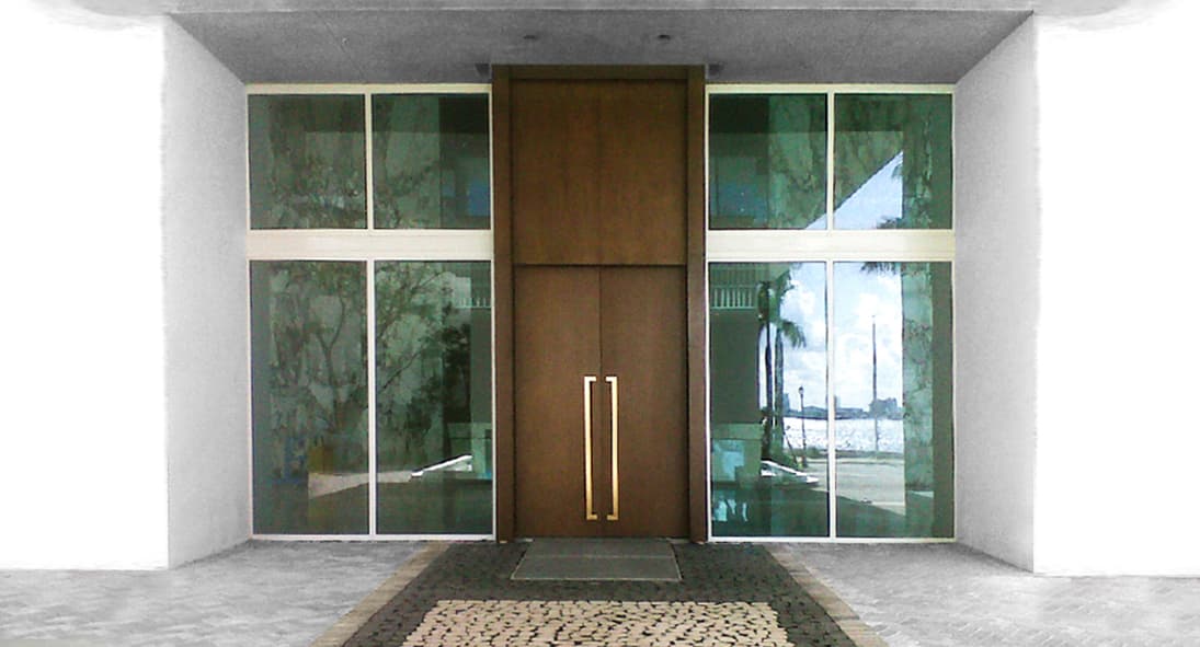 Modern commercial mahogany pivot door with glass storefront